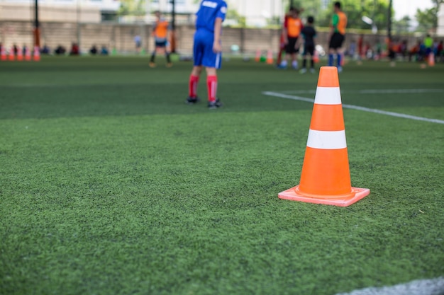 Soccer ball tactics on grass field with cone for training background Training children in Soccer academy