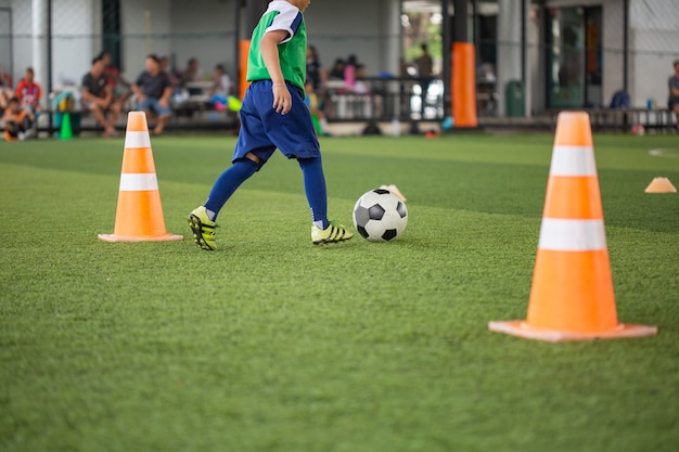 Soccer ball tactics on grass field with cone for training thailand in  background Training children in Soccer academy