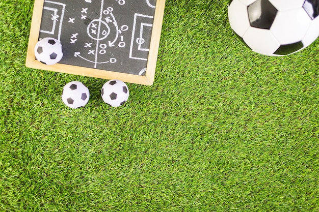 Soccer balls on a artificial turf as background.