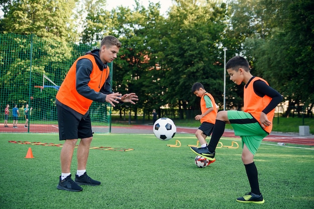 Soccer coach instructs teen players.