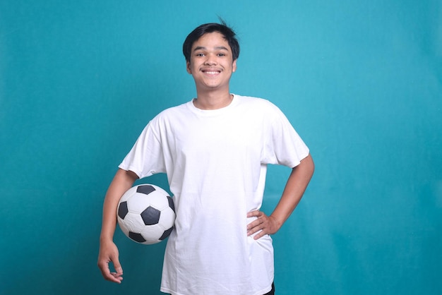 Soccer fan supporting favorite team. Portrait of happy excited cheerful man holding football, lookin