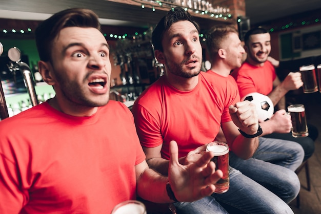 Soccer fans waiting for goal at sports bar.