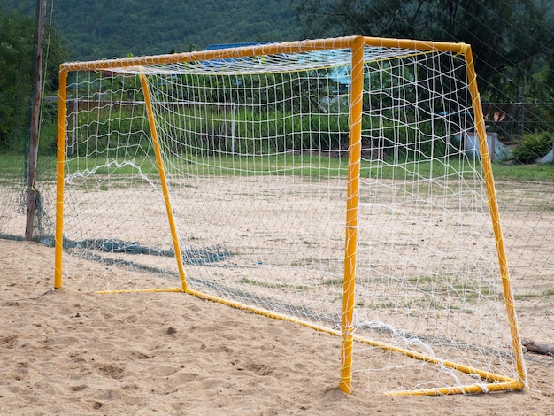 Soccer goal on sandy field in rural area