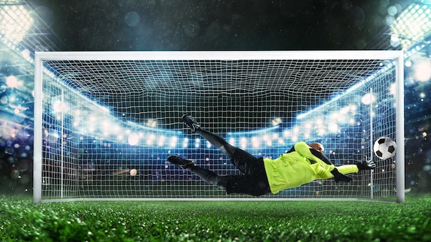 Soccer goalkeeper in fluorescent uniform that makes a great save and avoids a goal during a match at...