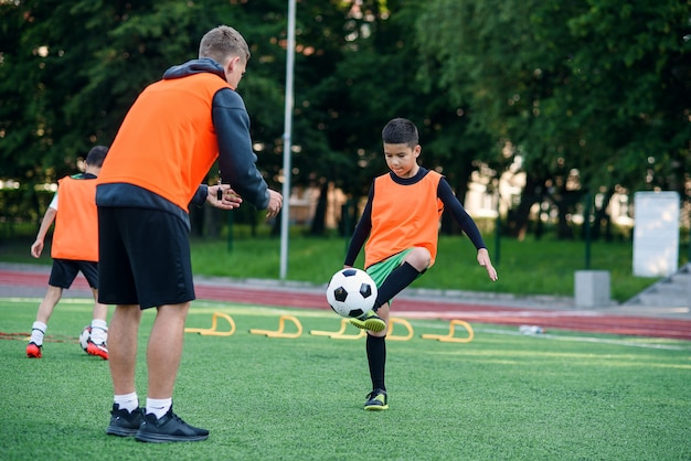 Soccer player kicking ball on field