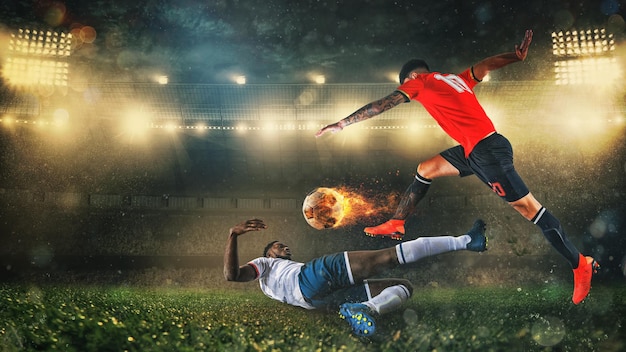 Soccer scene at night match with player in a red uniform kicking a fiery ball with power