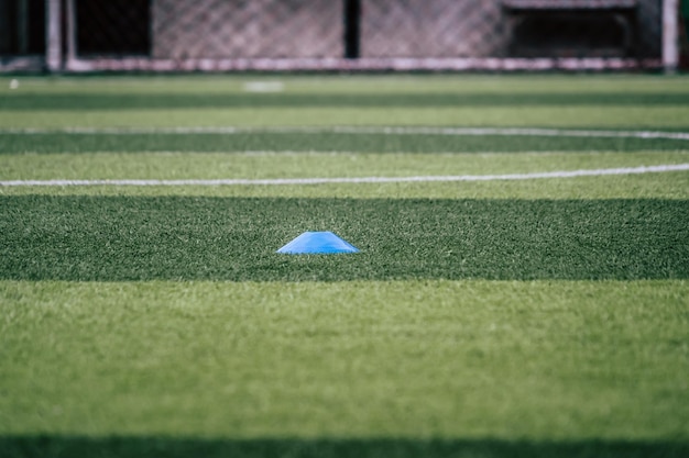 Soccer sport training equipments marker on green outdoor soccer training field