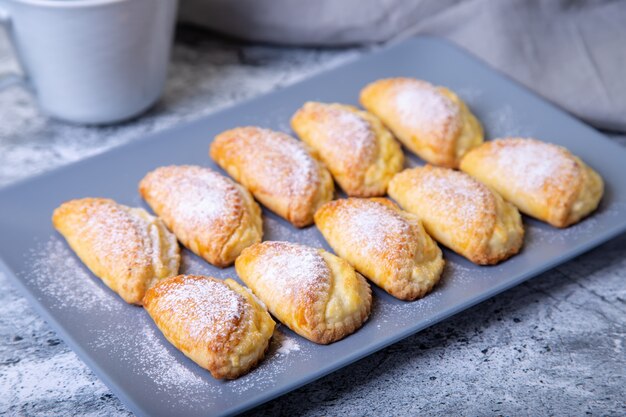 Sochniki (sochni) with cottage cheese. Traditional Russian shortbread with cottage cheese. Close-up, selective focus.