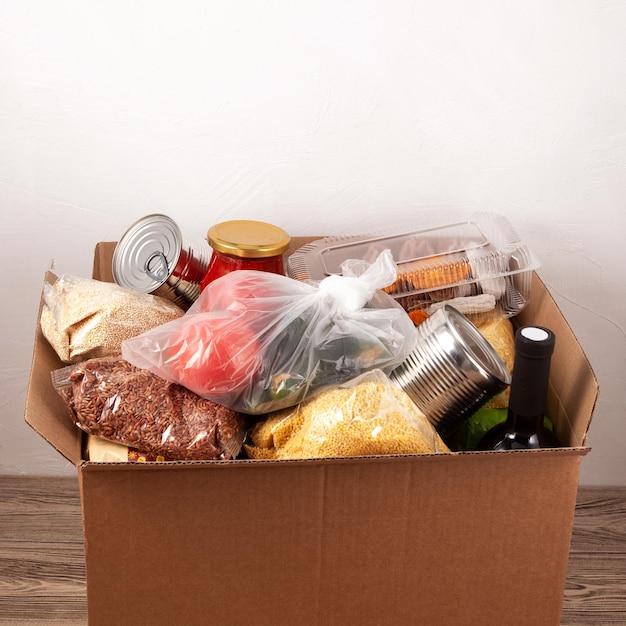 Social food donation Safe contactless home food delivery Cardboard box with different food products Safe express delivery concept Selective focus copy space