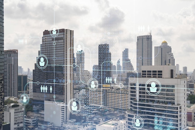 Social media icons hologram over panorama city view of Bangkok Southeast Asia The concept of people networking connections and career opportunities Double exposure