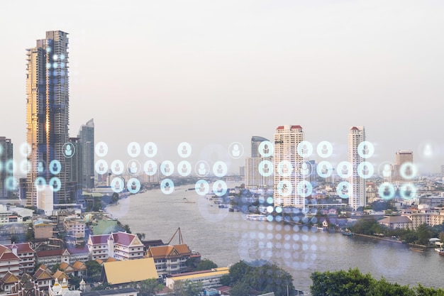 Social media icons hologram over panorama city view of Bangkok Southeast Asia The concept of people networking connections and career opportunities Double exposure