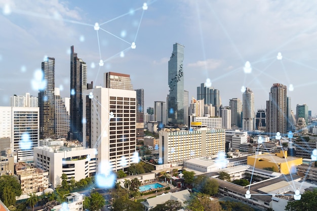 Social media icons hologram over panorama city view of Bangkok Southeast Asia The concept of people networking connections and career opportunities Double exposure