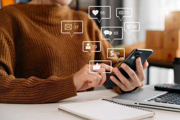 Social media and Marketing virtual icons screen conceptclose up of businesswoman typing keyboard tablet with laptop computer and smart phone