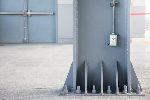 Socket or Receptacle stuck on the wall of a large scrap on the background of a building door for electrical systems concepts in buildings and homes