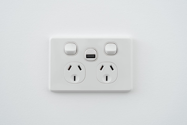 Socket with usb interface and switch on white wall