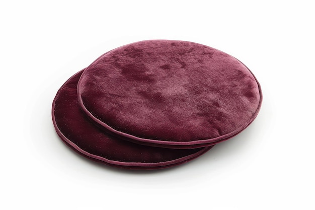 Soft burgundy round cushions placed on a white surface ideal for home decor and comfort