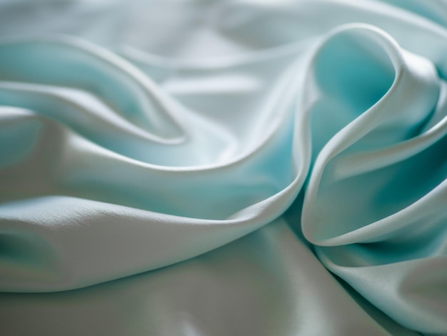 Soft fabric with beautiful folds of light color in a blur.