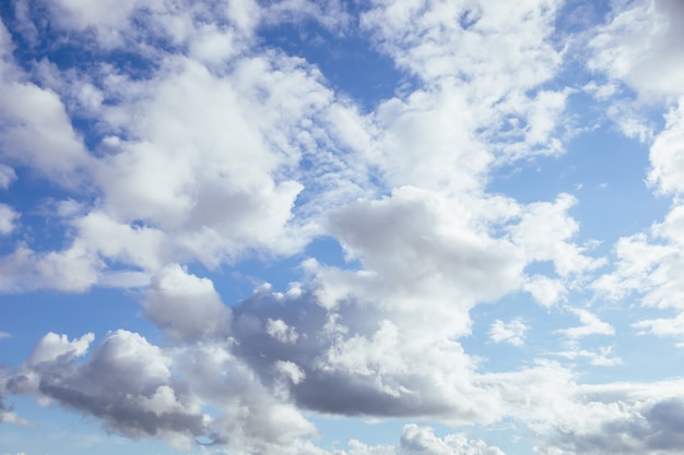 Soft and fluffy clouds formation on the bright sunny blue sky nature abstract background fresh air weather concept