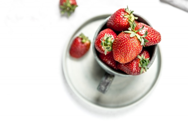 Soft focus of fresh ripe red strawberry in ceramic bowl