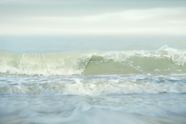 Soft focus and tone of sea wave on the sandy beachSummer vacation background