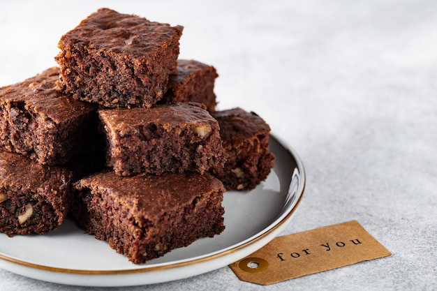 Soft focus zucchini brownies with walnuts on a plate