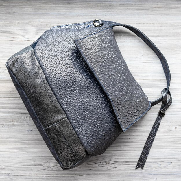 Soft handcrafted grey leather handbag on gray