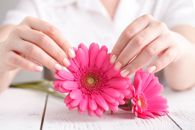 Soft tender protection for woman critical days, gynecological menstruation cycle, pink gerbera in hand