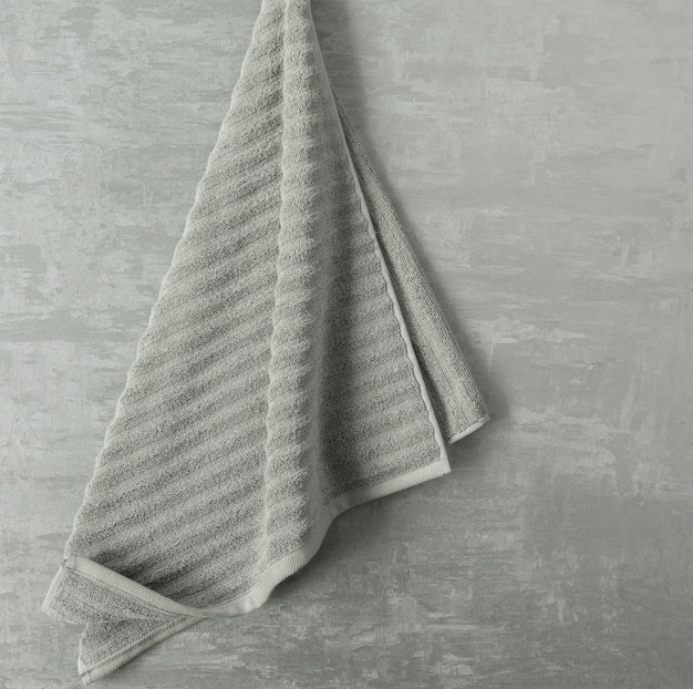 Soft towel in a grey  decorative stucco background. top view, isolated