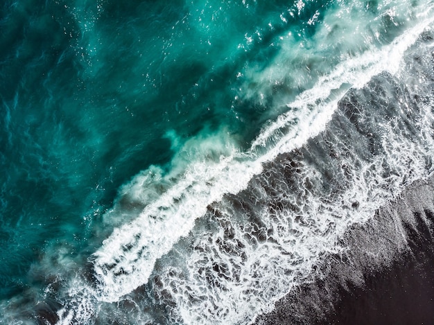 Soft wave of blue ocean on sandy beach. Background.