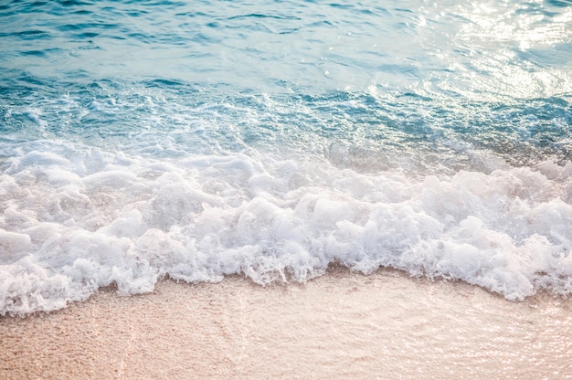 Soft wave of blue ocean on sandy beach