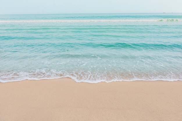 Soft wave of sea on empty sandy beach Background with copy space