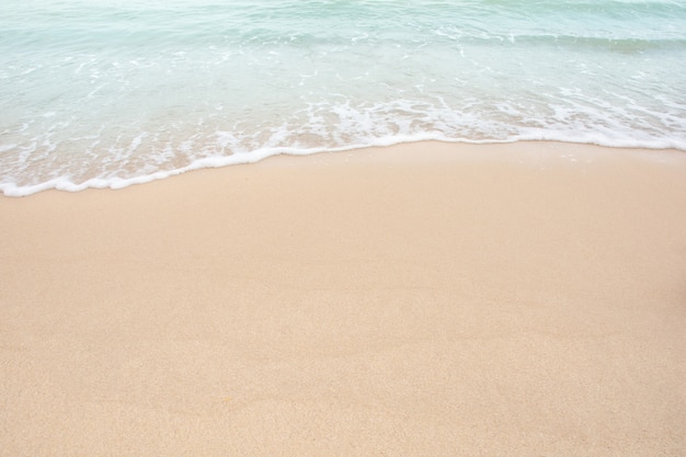 Soft wave of sea on empty sandy beach 