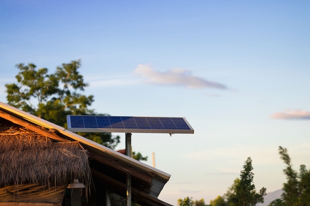 Solar energy panel or photovoltaic on roof of house in the countryside and blue sky 