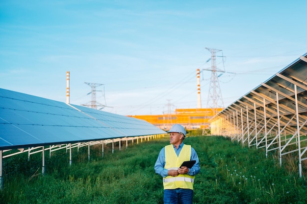 Solar engineer walking in solar farm alternative eco energy concept high quality photo