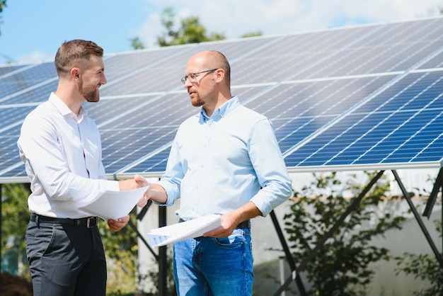 The solar farmsolar panel with two engineers walk to check the operation of the system Alternative energy to conserve the world's energy Photovoltaic module idea for clean energy production