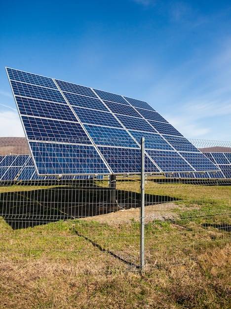 Solar panels against mountains landscape and blue sky