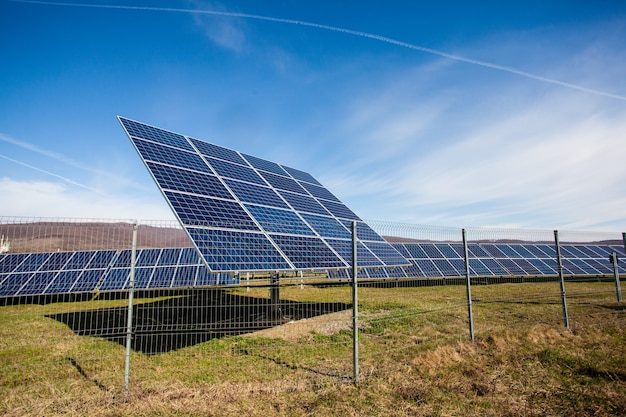 Solar panels against mountains landscape and blue sky