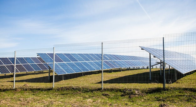 Solar panels against mountains landscape and blue sky