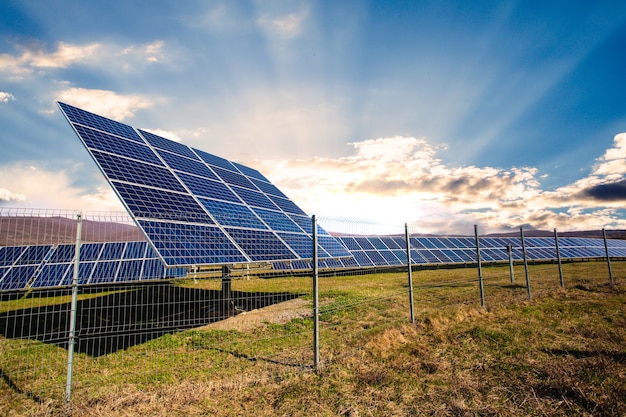 Solar panels against mountains landscape and blue sky