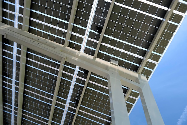 Solar panels installed as shade roof over parking lot for parked electric cars for effective generation of clean electricity Photovoltaic technology integrated in urban infrastructure