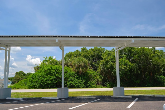 Solar panels installed over parking lot canopy shade for parked cars for effective generation of clean energy