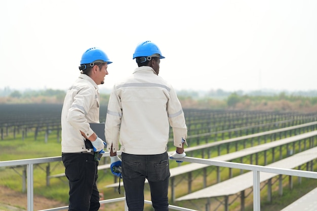 Solar power plant engineer examining photovoltaic panels technician maintenance electric solution