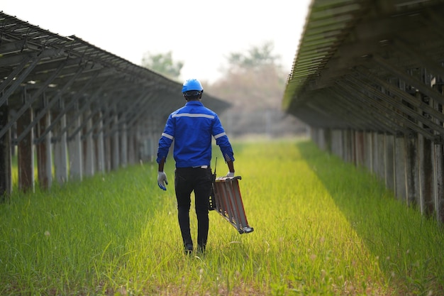 Solar power plant engineer examining photovoltaic panels technician maintenance electric solution