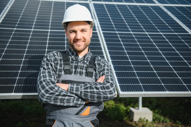 Solar power plant worker checks the condition of the panels