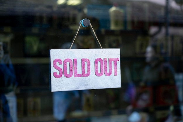 The sold out text on board hang on the store glass design sales season