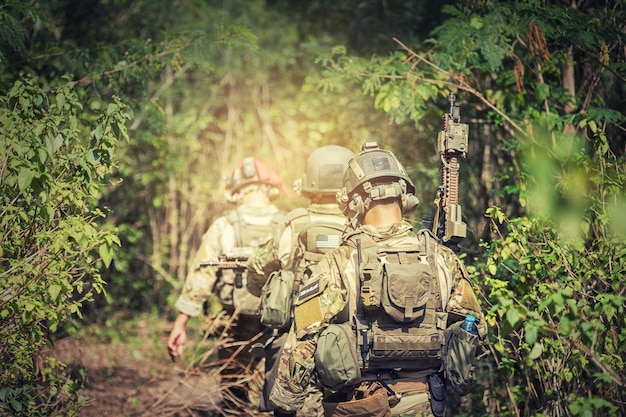 Soldier holding gun with full army uniform