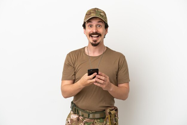 Soldier man isolated on white background surprised and sending a message