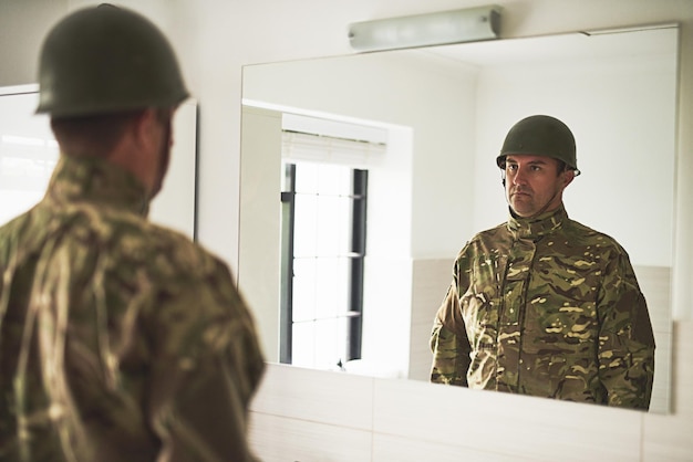 Soldier mirror and man in uniform home and mental health with psychology doubt and sad Apartment reflection and trooper with anxiety depression or army fighter with service military or veteran