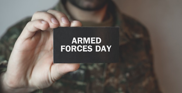 Soldier showing text Armed Forces Day.