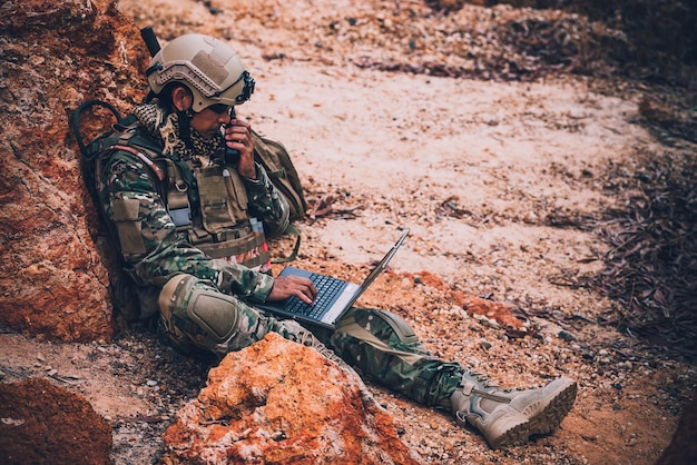 Soldiers of special forces on wars at the desertThailand peopleArmy soldier use laptop for see map with satelliteUsing Radio For Communication During Military Operation